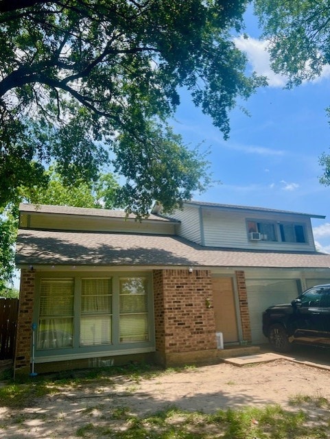 17102 Dewgrass Dr, Houston, TX 77060 - view of front of property featuring brick siding, an attached garage, dirt driveway, and fence
