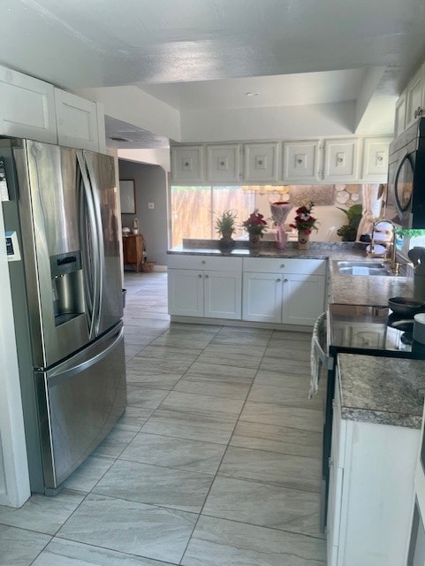 17102 Dewgrass Dr, Houston, TX 77060 - kitchen featuring appliances with stainless steel finishes, a sink, white cabinetry, and dark countertops