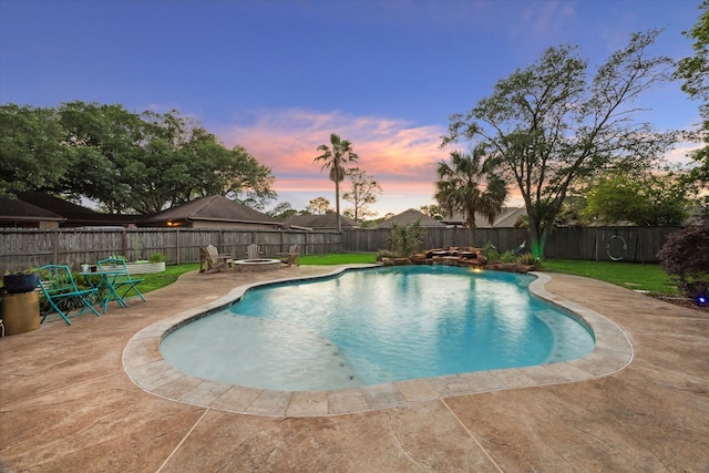 15907 Turtle Bay Dr, Houston, TX 77062 - pool at dusk featuring a patio area and a fire pit