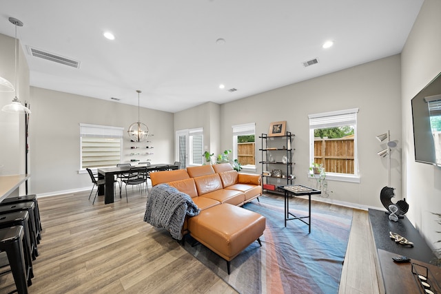 413 Stonework Oaks Ln, Houston, TX 77076 - living area featuring light wood-style floors, a chandelier, recessed lighting, and baseboards