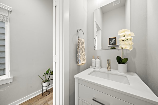 413 Stonework Oaks Ln, Houston, TX 77076 - bathroom featuring wood finished floors, vanity, and baseboards