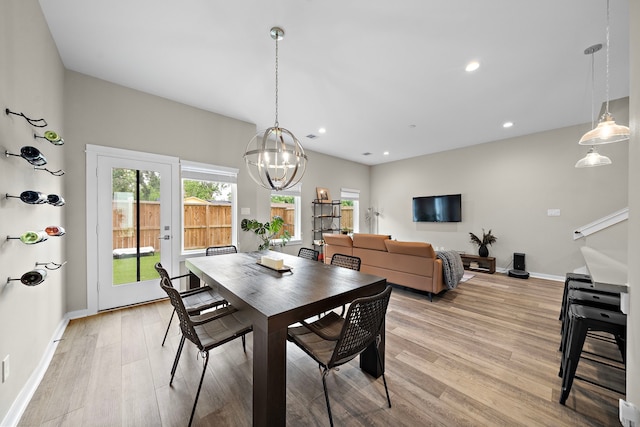 413 Stonework Oaks Ln, Houston, TX 77076 - dining area featuring light wood-style flooring, baseboards, a chandelier, and recessed lighting