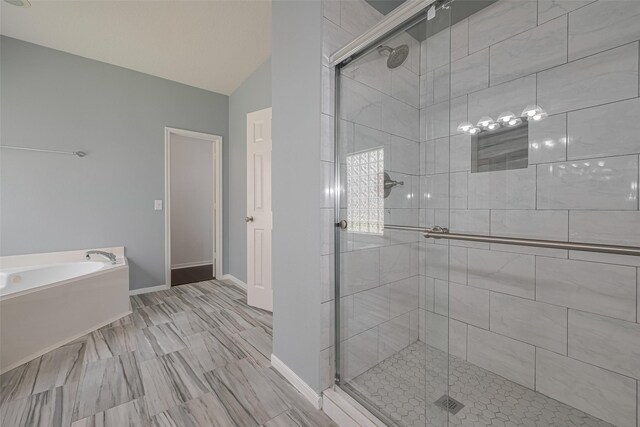 9205 Sunridge Ct, Pearland, TX 77584 - full bath with a shower stall, a bath, baseboards, and vaulted ceiling