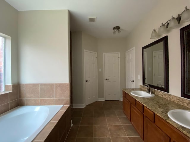3603 Morgans Cove Ct, Katy, TX 77494 - full bath with a garden tub, tile patterned floors, double vanity, and baseboards