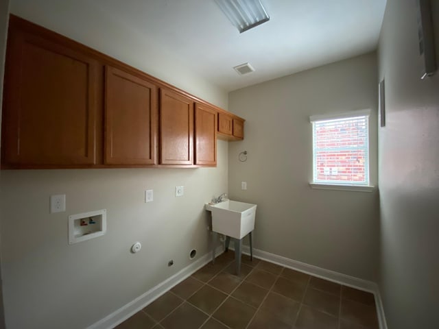 3603 Morgans Cove Ct, Katy, TX 77494 - clothes washing area featuring gas dryer hookup, hookup for a washing machine, cabinet space, baseboards, and dark tile patterned flooring