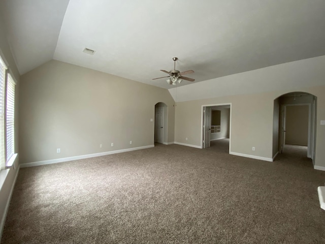 3603 Morgans Cove Ct, Katy, TX 77494 - unfurnished living room with arched walkways, vaulted ceiling, a ceiling fan, dark colored carpet, and baseboards