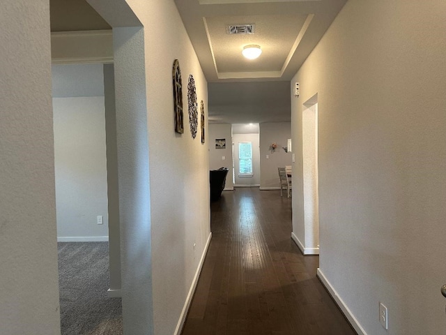 12148 Brazos Dr, Willis, TX 77378 - hallway with a raised ceiling, wood-type flooring, and baseboards