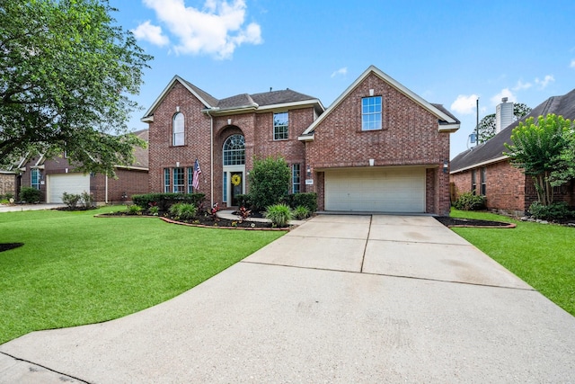 24918 Corbin Gate Dr, Spring, TX 77389 - traditional-style house featuring brick siding, concrete driveway, a garage, and a front yard