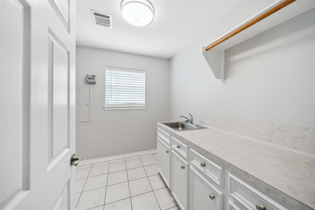 5224 Shorewood Dr, Willis, TX 77318 - washroom featuring a sink, light tile patterned floors, and baseboards