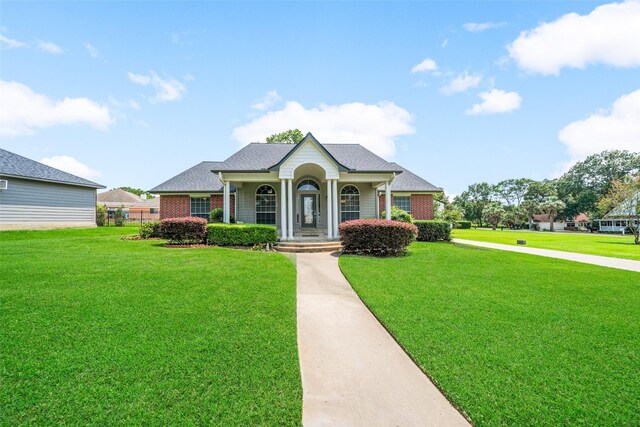 5224 Shorewood Dr, Willis, TX 77318 - view of front of house featuring a front lawn and brick siding