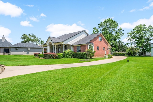 5224 Shorewood Dr, Willis, TX 77318 - view of front facade with a front lawn and brick siding