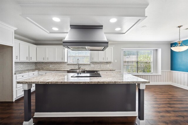 5224 Shorewood Dr, Willis, TX 77318 - kitchen featuring island exhaust hood, a sink, dark wood-style flooring, white cabinetry, and wainscoting