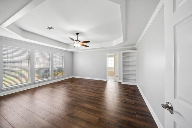 5224 Shorewood Dr, Willis, TX 77318 - unfurnished bedroom with a tray ceiling, dark wood-type flooring, baseboards, and a ceiling fan