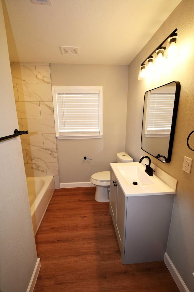 8130 Sharondale Dr, Houston, TX 77033 - bathroom with toilet, vanity, baseboards, and wood finished floors