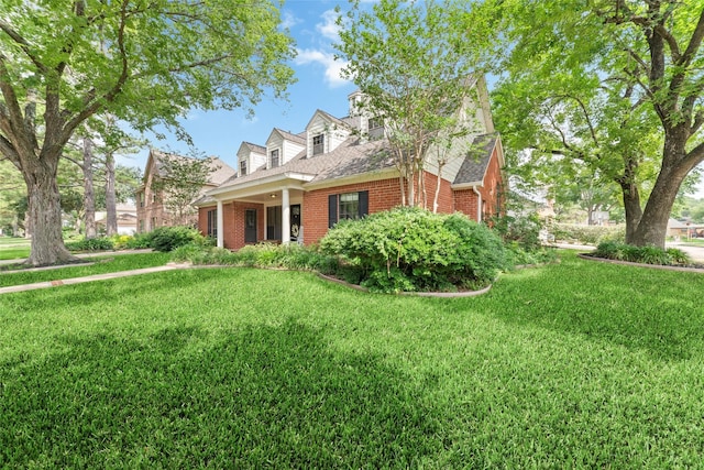 14926 Royal Birkdale St, Houston, TX 77095 - view of front of home with brick siding, a front yard, and roof with shingles