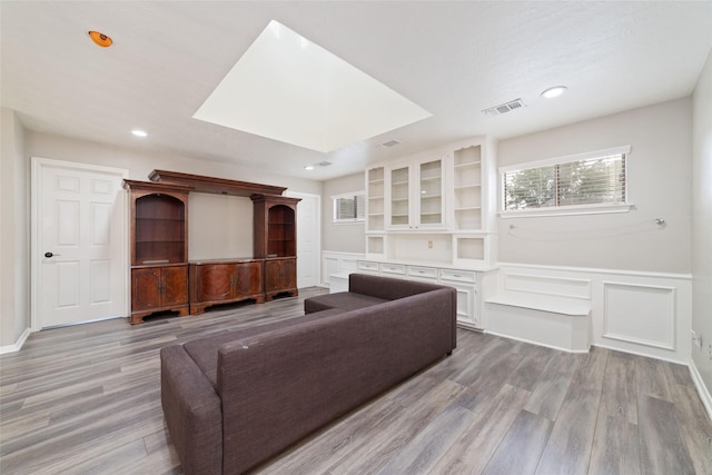 14926 Royal Birkdale St, Houston, TX 77095 - living room with light wood finished floors, a wainscoted wall, a decorative wall, and recessed lighting