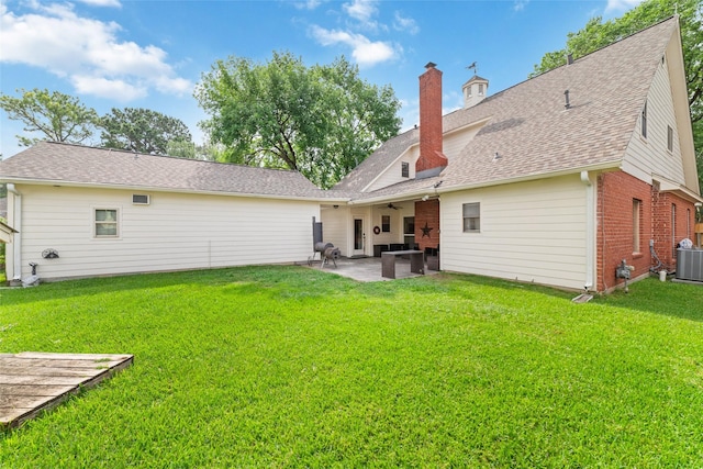 14926 Royal Birkdale St, Houston, TX 77095 - back of property with a ceiling fan, a patio area, a yard, a chimney, and brick siding