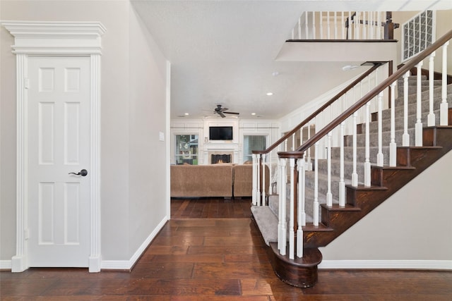 14926 Royal Birkdale St, Houston, TX 77095 - foyer featuring baseboards, hardwood / wood-style flooring, stairway, a ceiling fan, and a lit fireplace