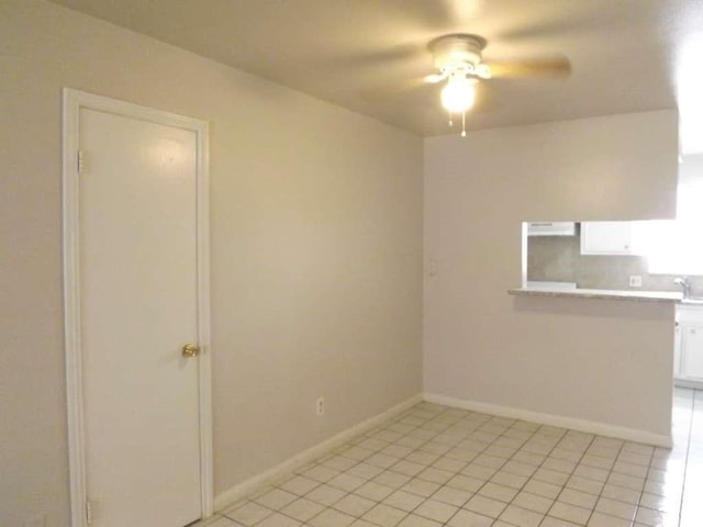 3114 Falk Ct Unit 3114, La Porte, TX 77571 - unfurnished dining area with a ceiling fan, light tile patterned floors, and baseboards