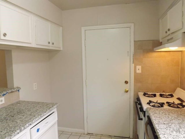 3114 Falk Ct Unit 3114, La Porte, TX 77571 - kitchen with under cabinet range hood, white appliances, white cabinetry, light stone counters, and light tile patterned floors