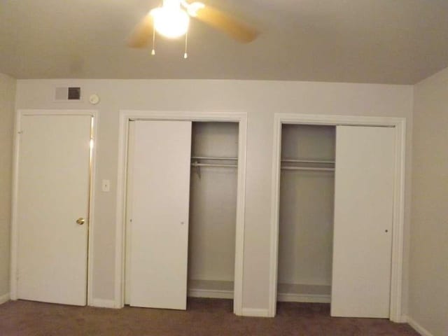 3114 Falk Ct Unit 3114, La Porte, TX 77571 - unfurnished bedroom featuring multiple closets, carpet floors, baseboards, and a ceiling fan