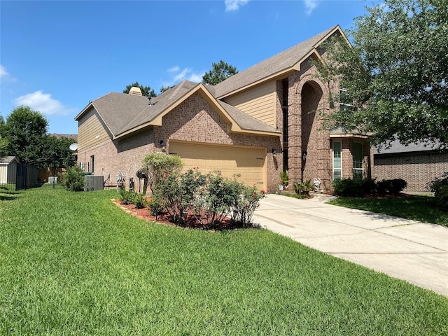 15 S Marshside Pl, Spring, TX 77389 - view of front of house with brick siding, a garage, concrete driveway, and a front lawn