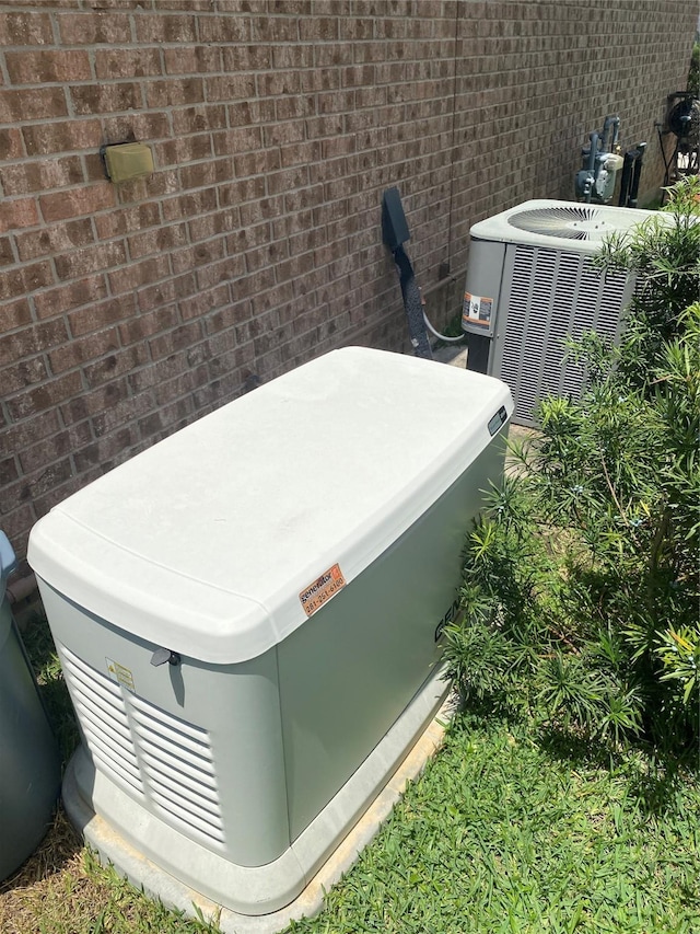 15 S Marshside Pl, Spring, TX 77389 - exterior view of a power unit, central air condition unit, and brick siding