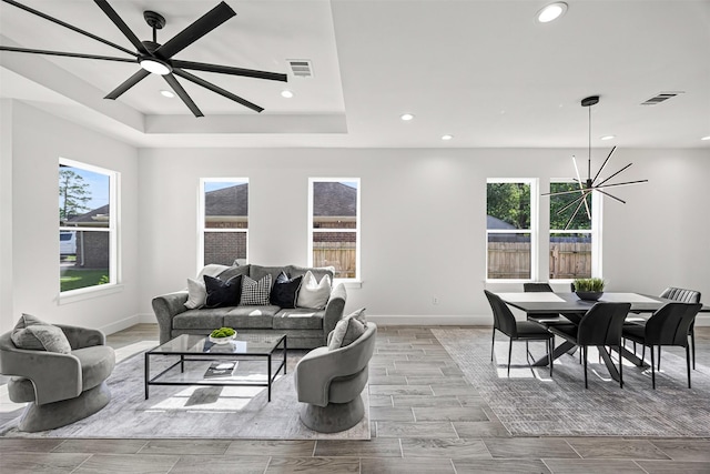 316 E Oakdale St, Dayton, TX 77535 - living room with recessed lighting, baseboards, a raised ceiling, wood tiled floors, and a chandelier