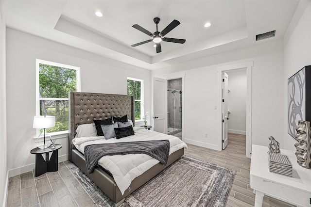 316 E Oakdale St, Dayton, TX 77535 - bedroom with a raised ceiling, multiple windows, wood tiled floors, baseboards, and recessed lighting