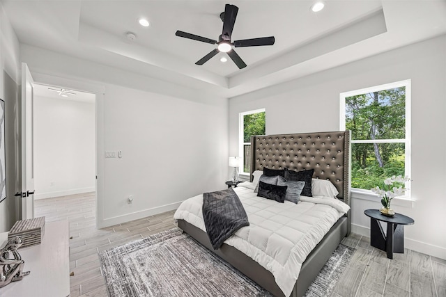 316 E Oakdale St, Dayton, TX 77535 - bedroom with a raised ceiling, wood tiled floors, recessed lighting, baseboards, and a ceiling fan