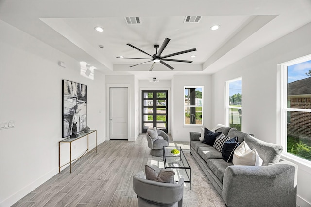 316 E Oakdale St, Dayton, TX 77535 - living area with a raised ceiling, light wood-style floors, plenty of natural light, baseboards, and recessed lighting