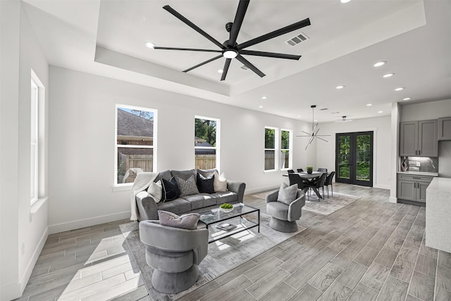 316 E Oakdale St, Dayton, TX 77535 - living room with a tray ceiling, a ceiling fan, recessed lighting, wood finish floors, and plenty of natural light