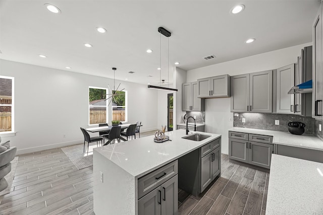 316 E Oakdale St, Dayton, TX 77535 - kitchen featuring a sink, gray cabinets, wood finish floors, and recessed lighting
