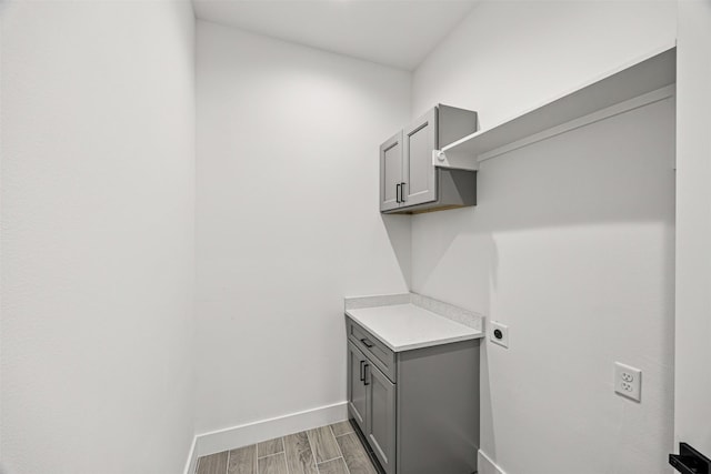 316 E Oakdale St, Dayton, TX 77535 - laundry area featuring hookup for an electric dryer, baseboards, and light wood-style flooring