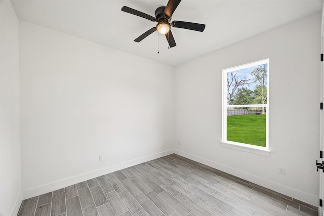 316 E Oakdale St, Dayton, TX 77535 - empty room featuring wood finish floors, baseboards, and a ceiling fan