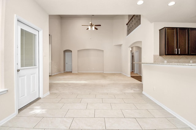 14542 Northern Mountain Ct, Houston, TX 77090 - empty room featuring arched walkways, a ceiling fan, recessed lighting, light colored carpet, and light tile patterned floors