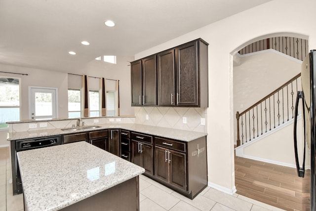 14542 Northern Mountain Ct, Houston, TX 77090 - kitchen featuring a sink, dark brown cabinetry, light stone counters, and recessed lighting