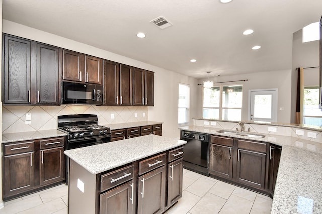 14542 Northern Mountain Ct, Houston, TX 77090 - kitchen featuring black appliances, a sink, decorative backsplash, light tile patterned flooring, and recessed lighting