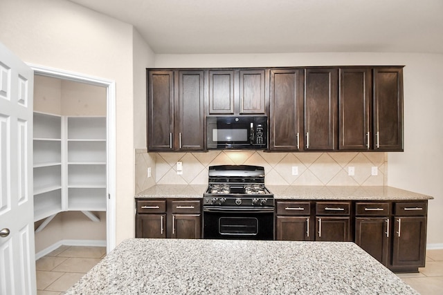 14542 Northern Mountain Ct, Houston, TX 77090 - kitchen featuring black appliances, light tile patterned flooring, dark brown cabinets, and decorative backsplash