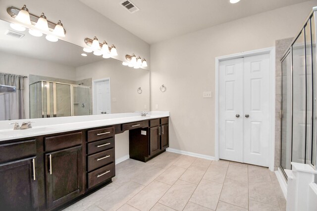14542 Northern Mountain Ct, Houston, TX 77090 - full bathroom featuring double vanity, a shower stall, tile patterned flooring, and baseboards