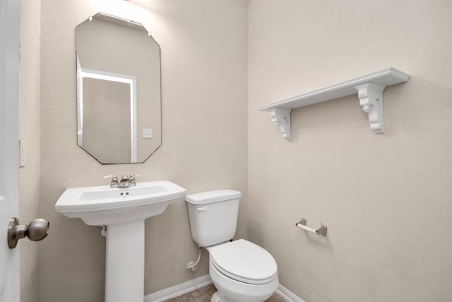 14542 Northern Mountain Ct, Houston, TX 77090 - bathroom featuring toilet, baseboards, and a sink