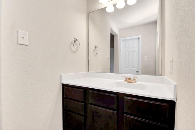 14542 Northern Mountain Ct, Houston, TX 77090 - bathroom with vanity and a textured wall