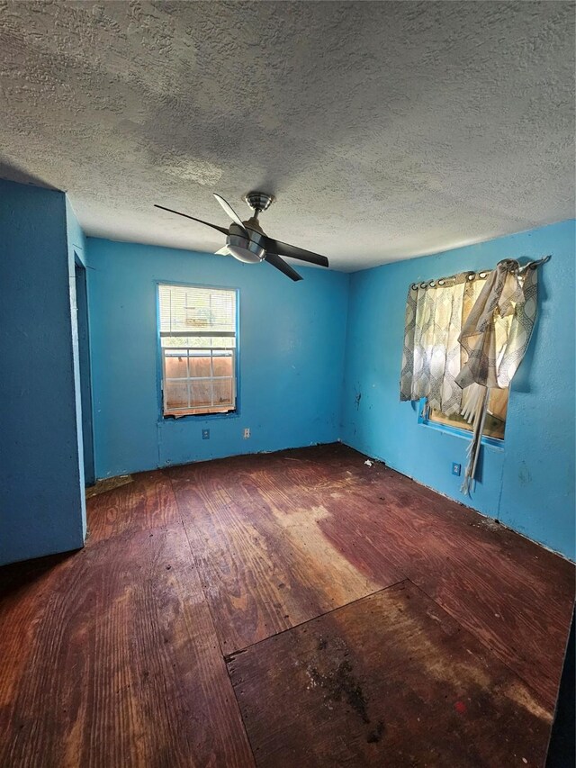 3131 Vintage St, Houston, TX 77026 - empty room featuring wood finished floors, a ceiling fan, and a textured ceiling
