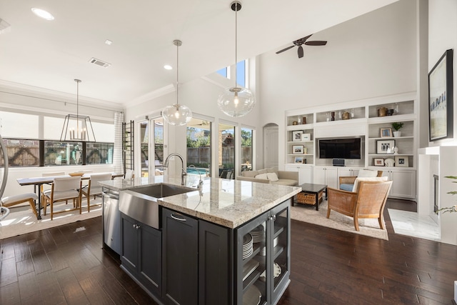 1211 Chamboard Ln, Houston, TX 77018 - kitchen with a sink, dark wood finished floors, dark cabinets, light stone countertops, and ornamental molding