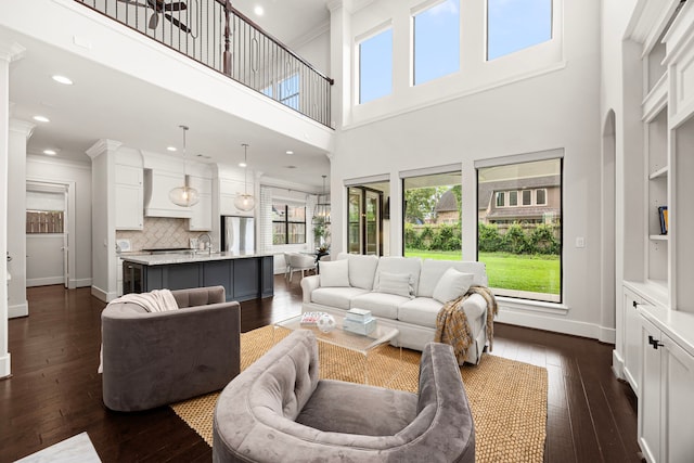 1211 Chamboard Ln, Houston, TX 77018 - living area with dark wood finished floors, baseboards, a towering ceiling, crown molding, and recessed lighting