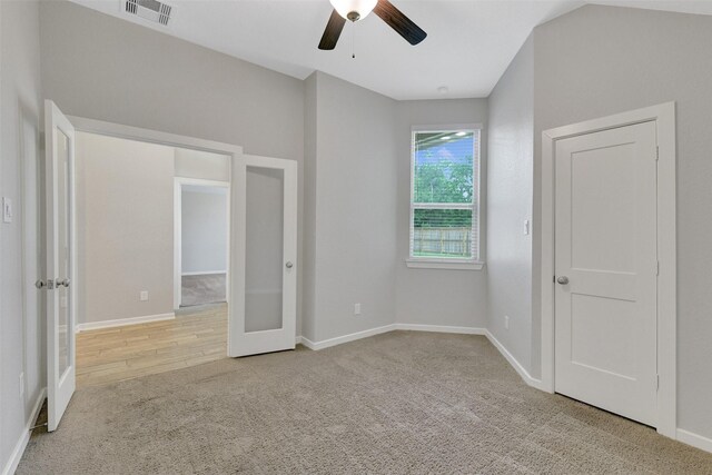 12407 Palo Acebo Ln, Humble, TX 77346 - unfurnished bedroom featuring carpet, ceiling fan, baseboards, and french doors