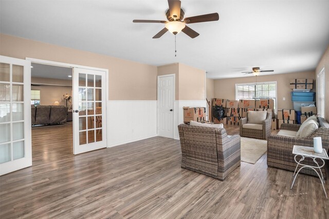 416 State Highway 21 E, Crockett, TX 75835 - living area featuring ceiling fan, french doors, wood finished floors, and wainscoting