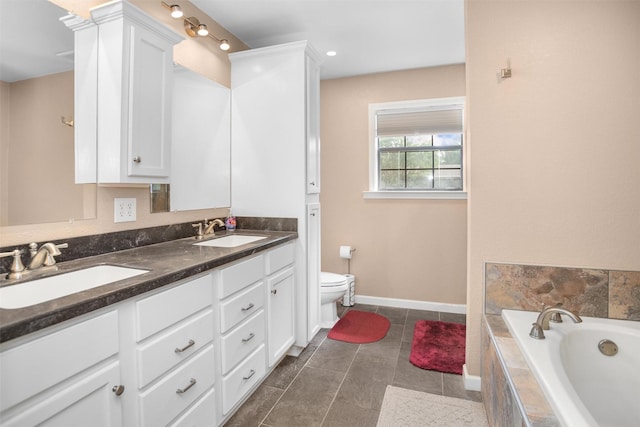 416 State Highway 21 E, Crockett, TX 75835 - bathroom with toilet, double vanity, tiled bath, baseboards, and tile patterned flooring