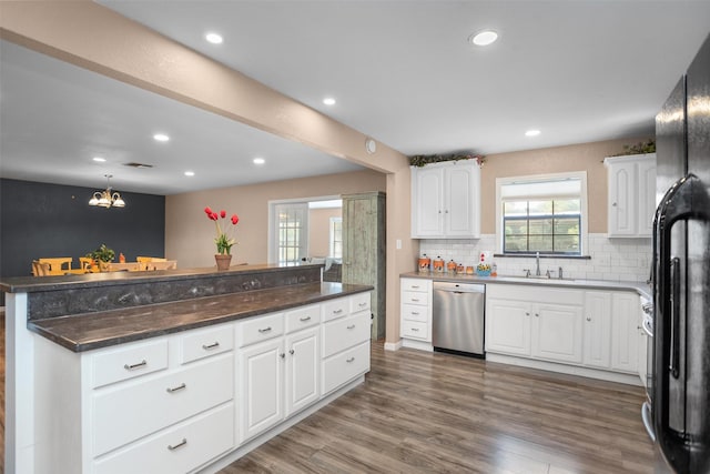416 State Highway 21 E, Crockett, TX 75835 - kitchen featuring dishwasher, a sink, black fridge, recessed lighting, and white cabinetry