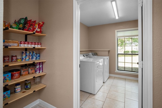416 State Highway 21 E, Crockett, TX 75835 - laundry area featuring washer and clothes dryer, light tile patterned flooring, and baseboards